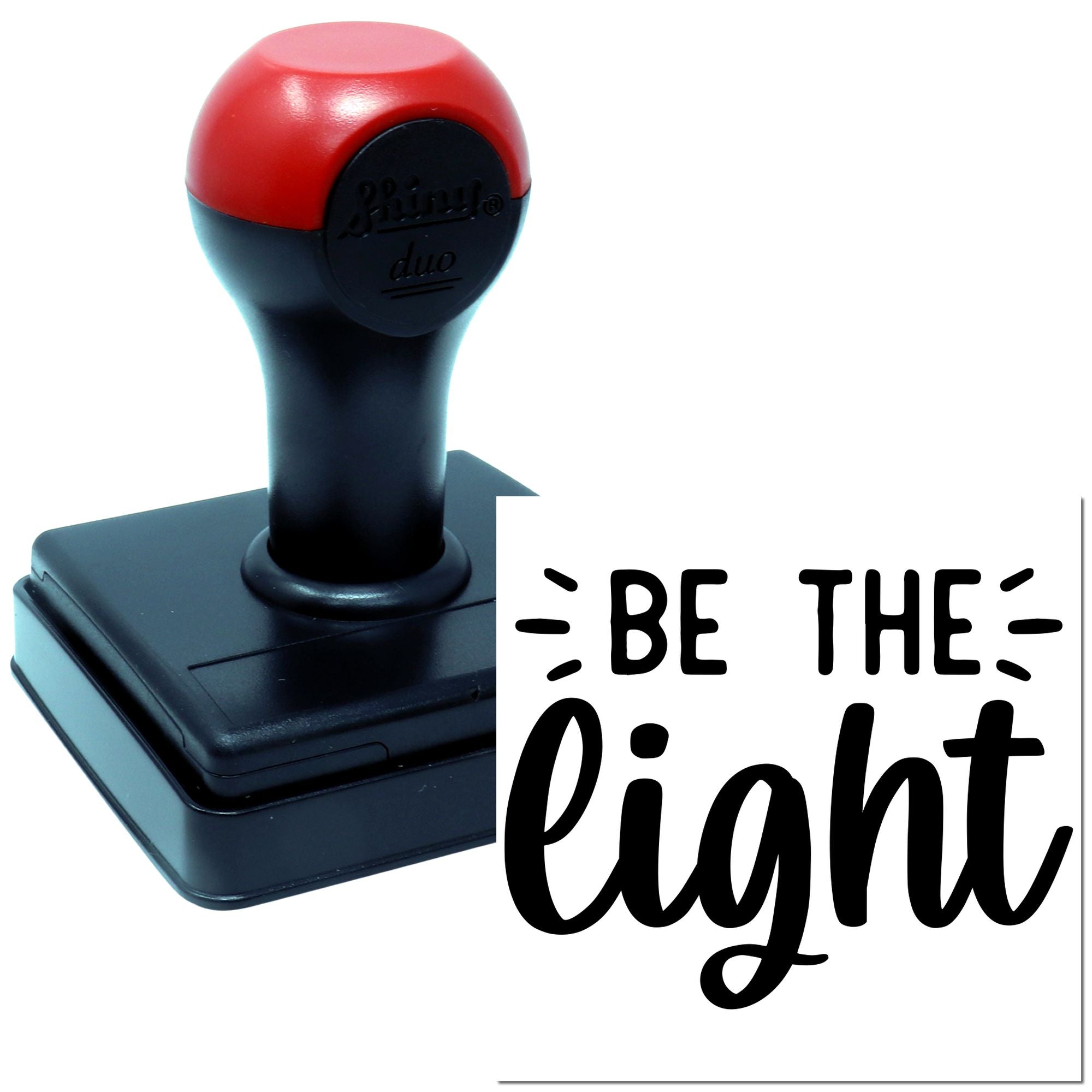 Self-inking rubber stamp imprint reading Be the Light for inspirational cards, crafts, and branding.