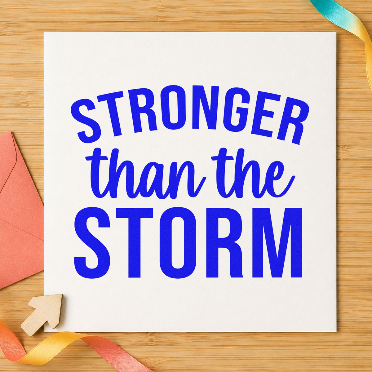 Stronger Than The Storm craft stamp in blue ink on cardstock, an easy option for volunteer cap printing.