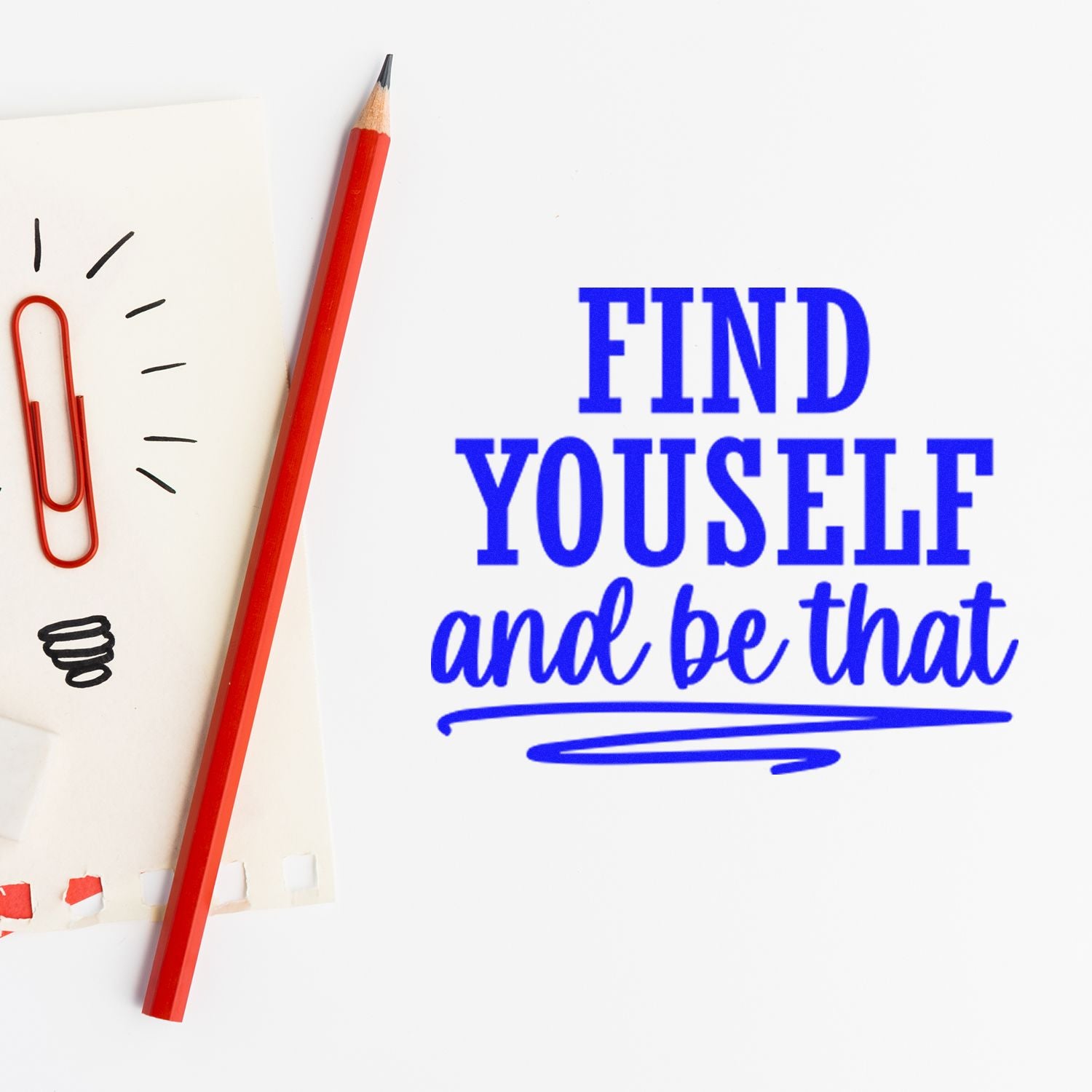 Inspirational rubber stamp text reading Find Yourself and Be That with pencil and note paper background.