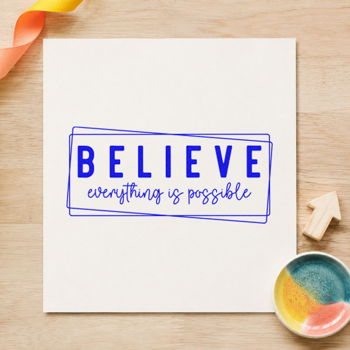 Believe Everything Is Possible craft stamp imprinted in blue ink on paper, a design suited to framed desk hutch.