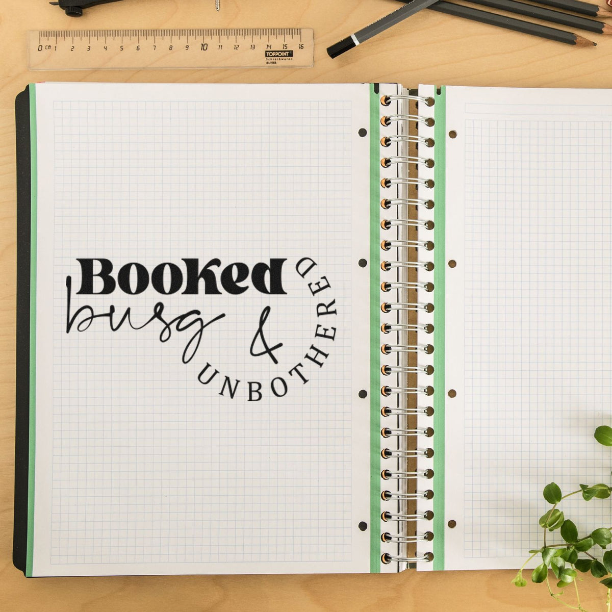 Booked Busy And Unbothered Premium Wooden Stamp - Vintage Pro imprint stamped in black ink. The words "Booked busy & unbothered" combine bold letters and fine script in a curved arrangement.