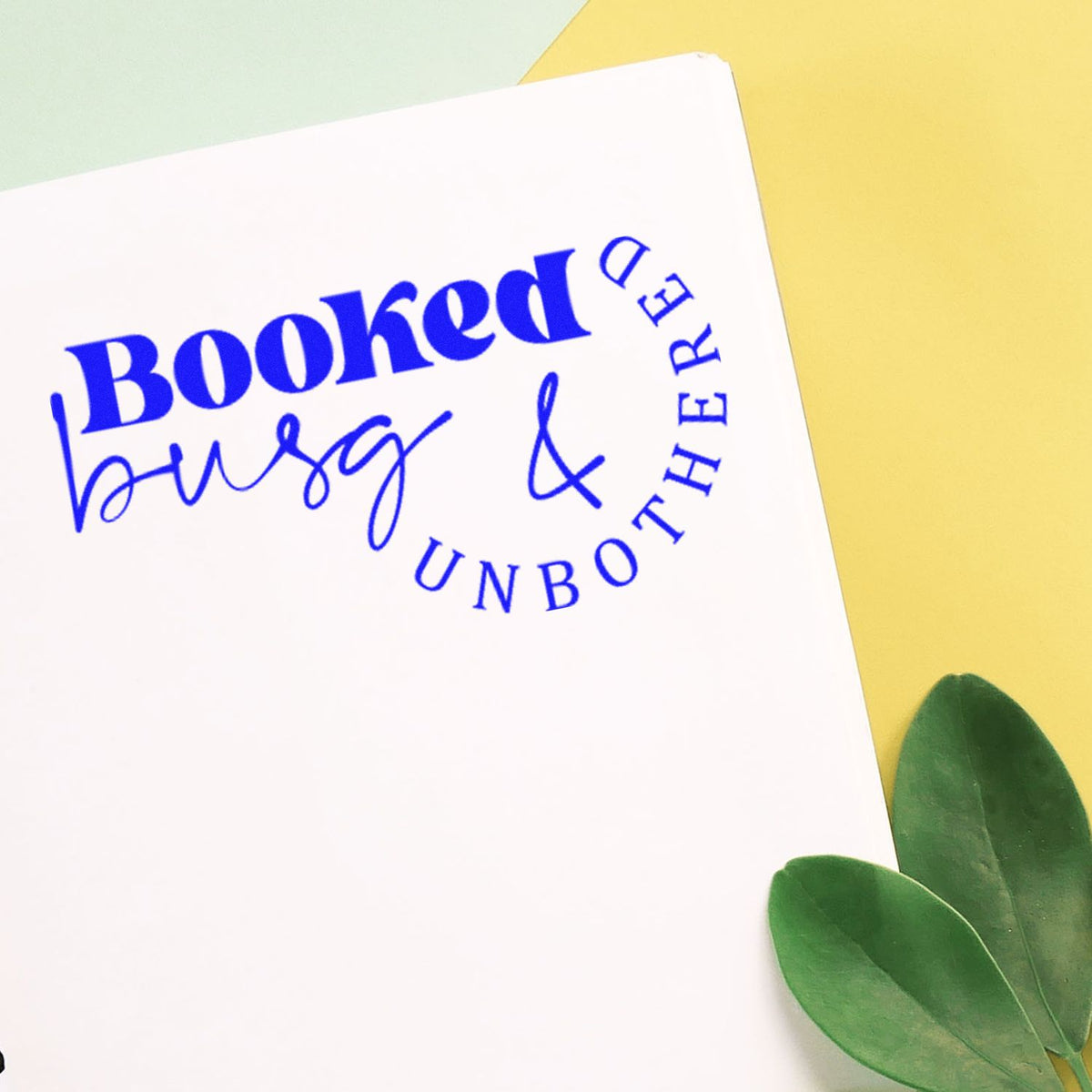 Booked Busy And Unbothered rubber stamp shown in blue ink, stamped for projects such as booth album page.