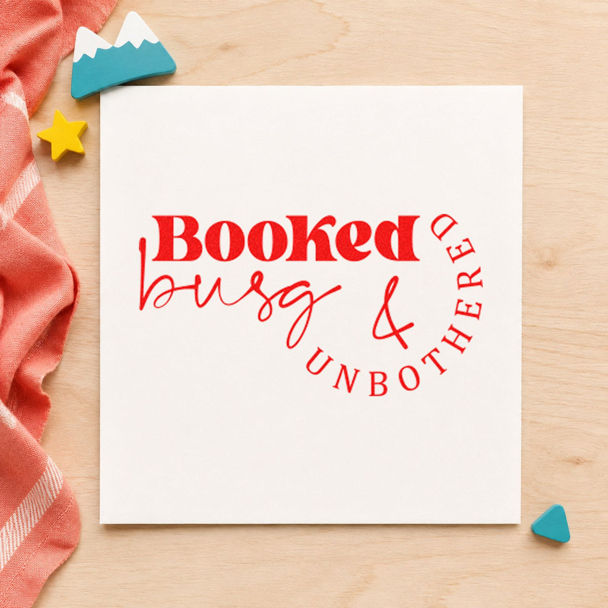 Booked Busy And Unbothered craft stamp imprint in red ink on a handmade project, one idea being rebook reminder cards.