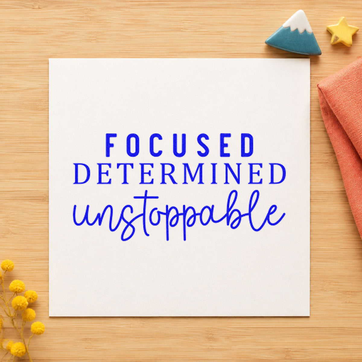 Focused Determined Unstoppable craft stamp imprinted in blue ink on paper, a design suited to framed office shelf.
