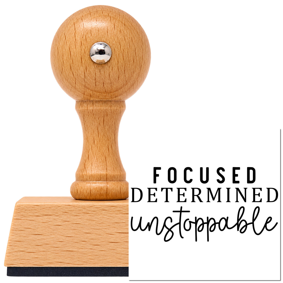 Focused Determined Unstoppable Serif Lettering Vintage Pro rubber stamp in European beech wood with a round knob handle, shown beside its black imprint.