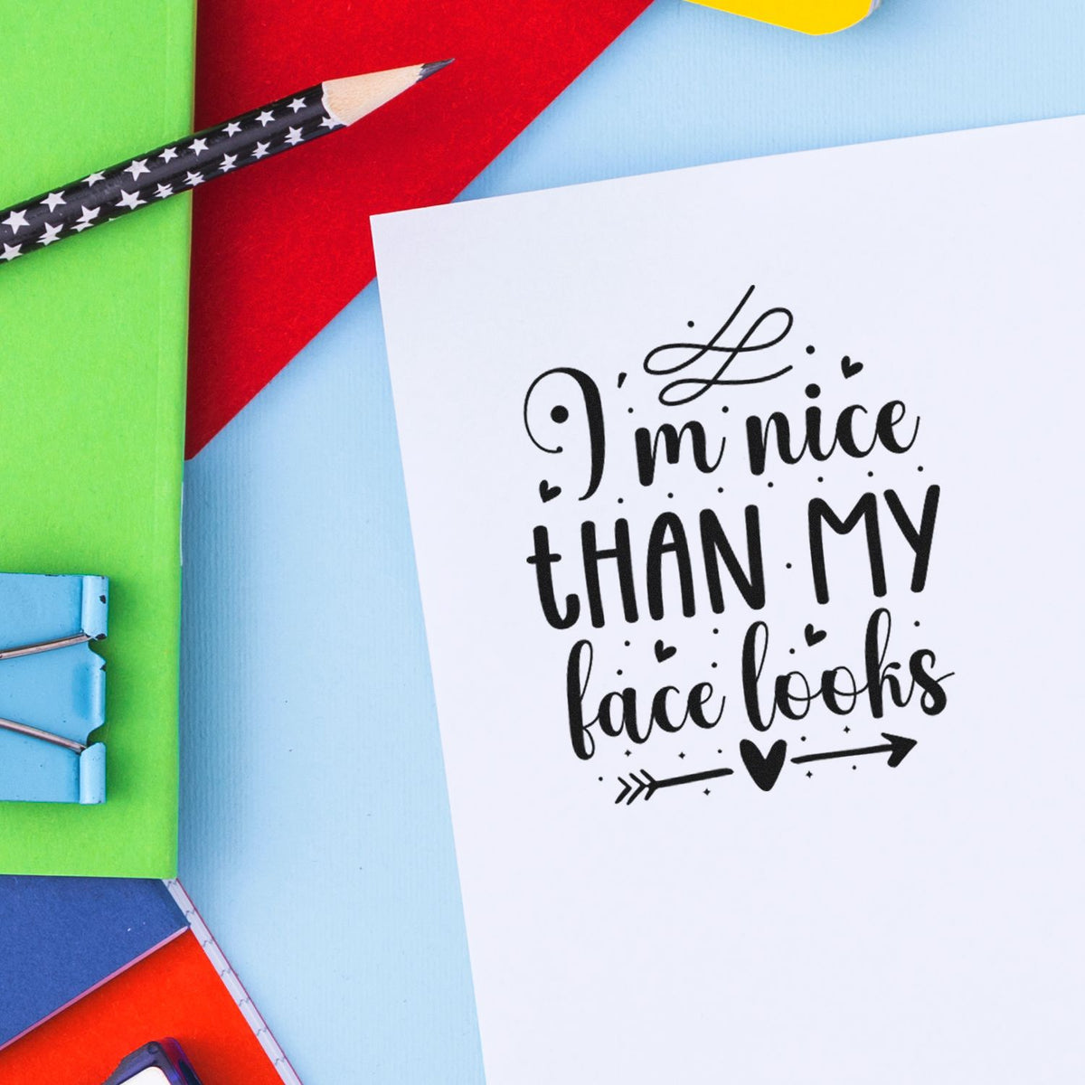 Nice Than My Face Looks Stamp - Premium Vintage Pro Wooden imprint stamped in black ink. The phrase "I'm nice than my face looks" appears with small hearts, dots, a top flourish, and an arrow below.
