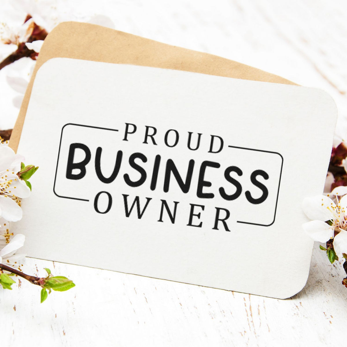 Proud Business Owner Frame Premium Wood-Mounted Stamp - Vintage Pro imprint stamped in black ink. The words "Proud business owner" appear in a thin partially open rectangular frame.