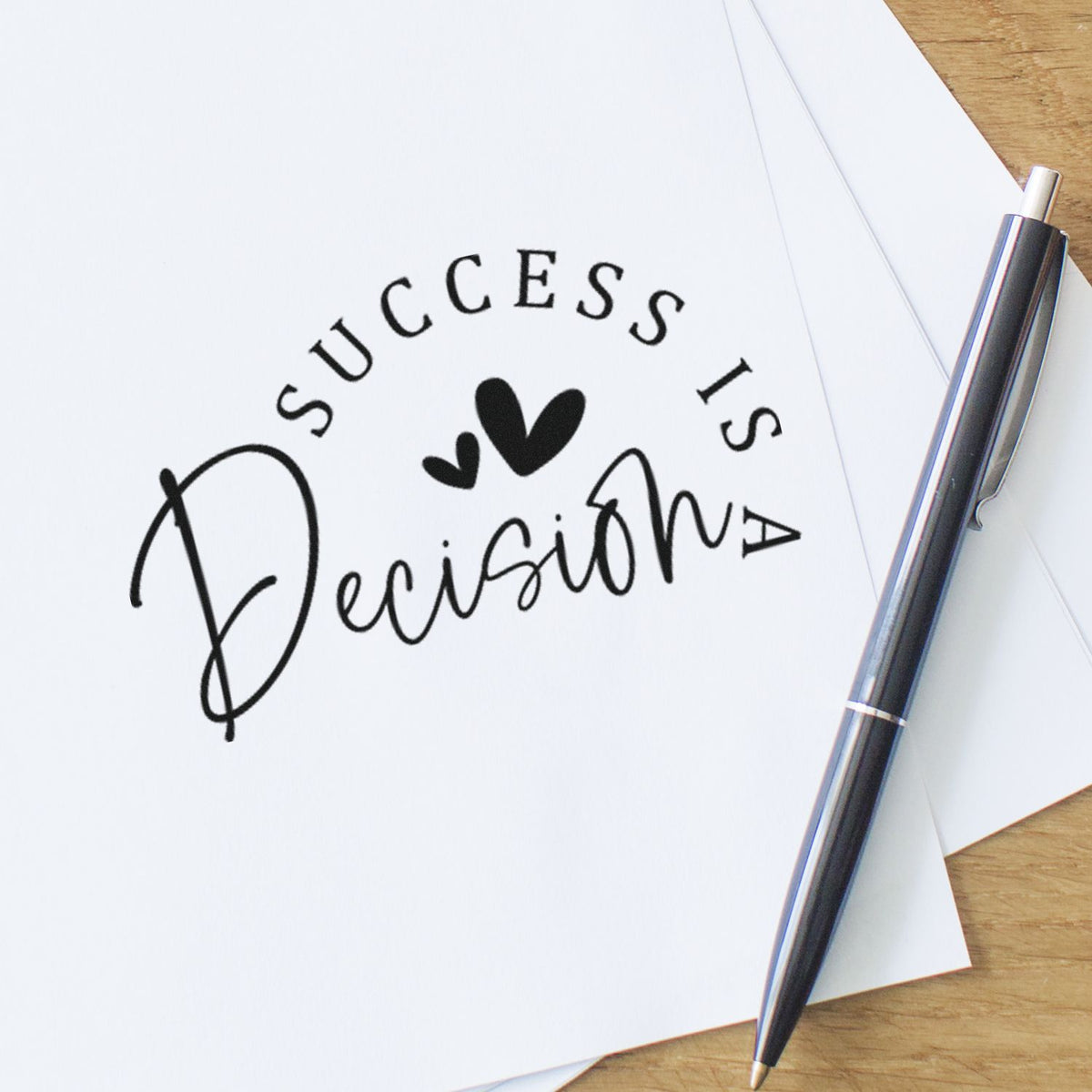 Success Is A Decision With Hearts Premium Wooden Stamp - Vintage Pro imprint stamped in black ink. The phrase "Success is a decision" forms a curved layout around two hearts.