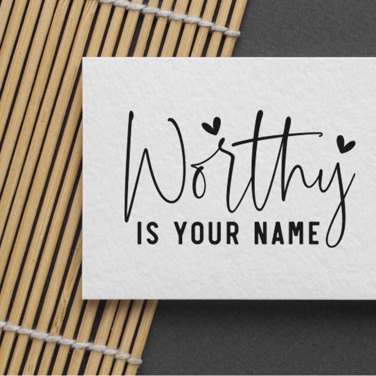 Worthy Is Your Name Premium Wooden Stamp - Vintage Pro imprint stamped in black ink. The phrase "Worthy is your name" combines large thin script and small bold capitals with hearts.