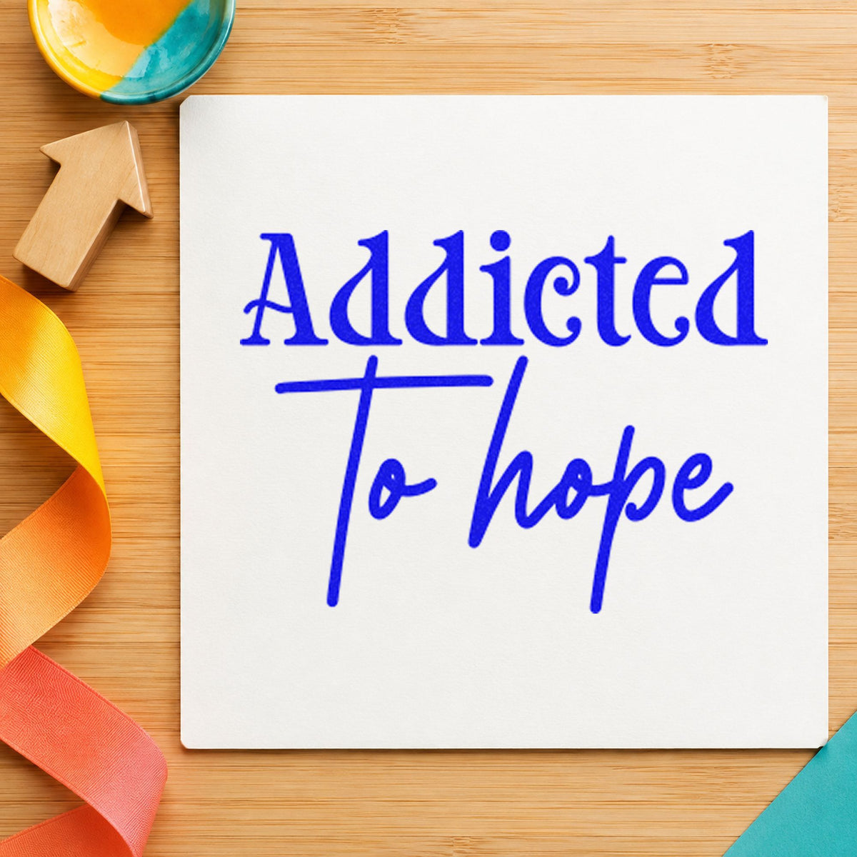 Addicted To Hope Lettering craft stamp imprinted in blue ink on paper, a design suited to framed tying bench.