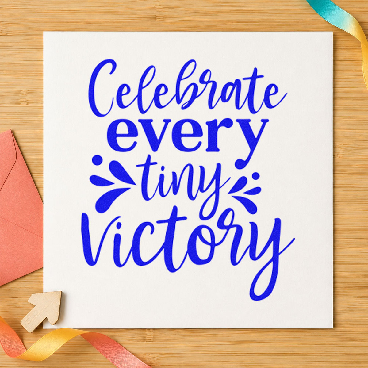 Celebrate Every Tiny Victory craft stamp in blue ink on cardstock, an easy option for sorting bag printing.