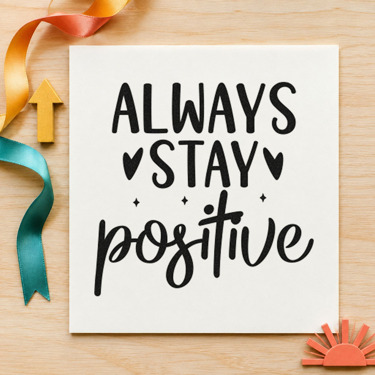 Always Stay Positive Hearts craft stamp imprint in black ink on a handmade project, one idea being award ribbon tags.