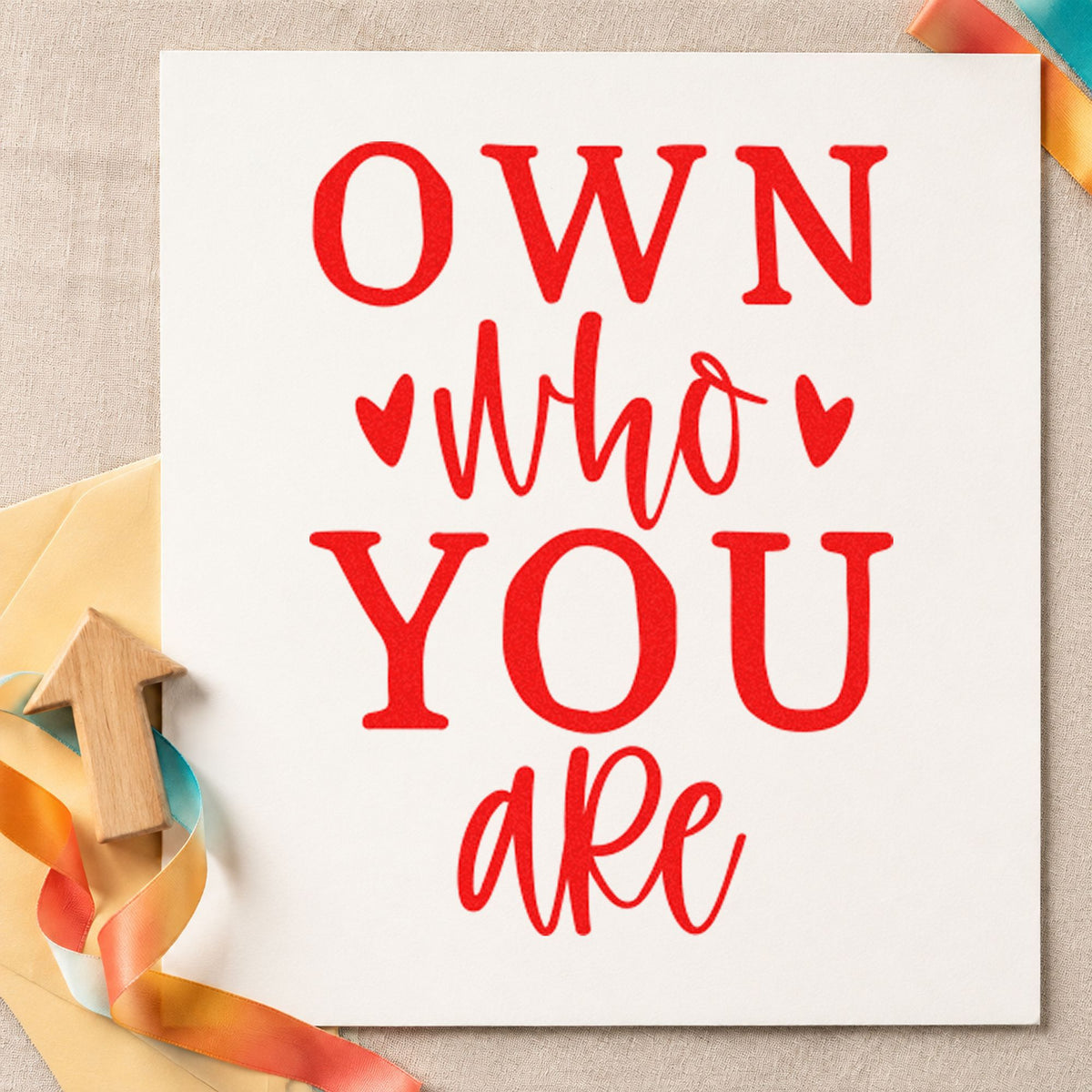 Own Who You Are craft stamp imprint in red ink on a handmade project, one idea being birthday party cards.