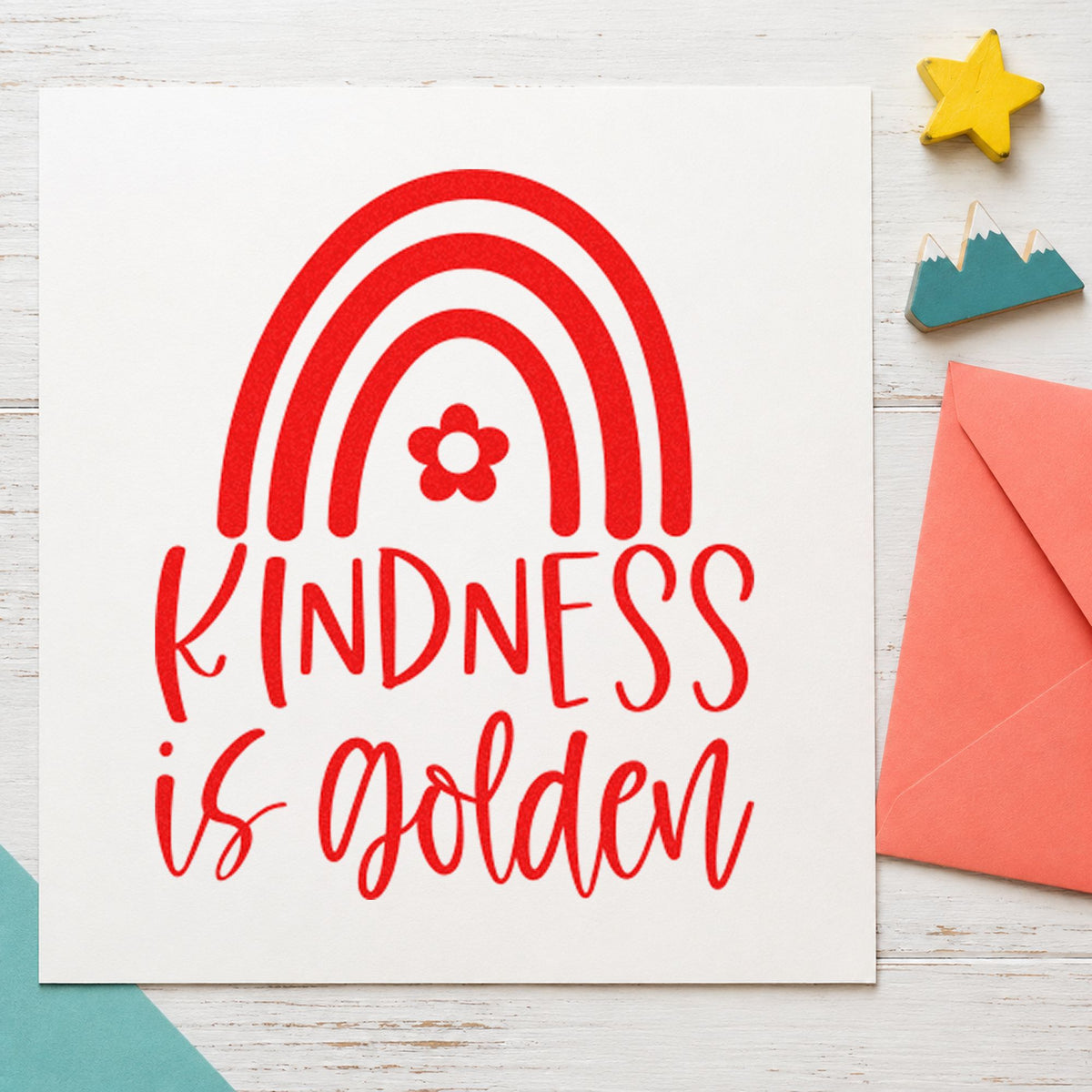 Kindness Is Golden Rainbow craft stamp imprint in red ink on a handmade project, one idea being safe walk cards.