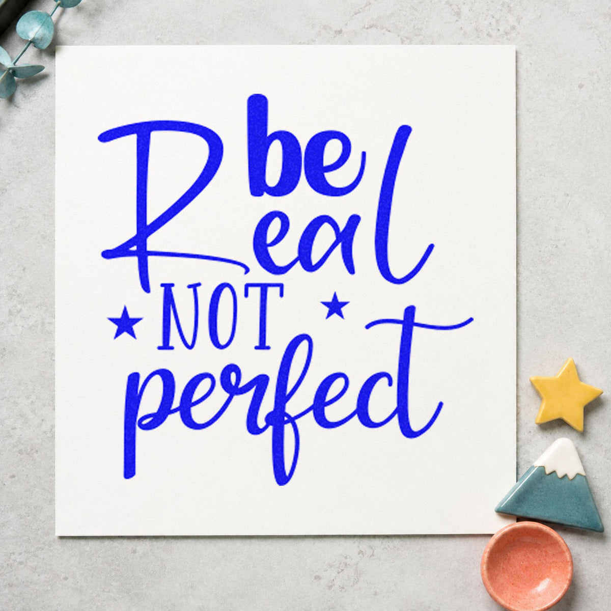 Be Real Not Perfect Stars craft stamp in blue ink on cardstock, an easy option for tote panel printing.