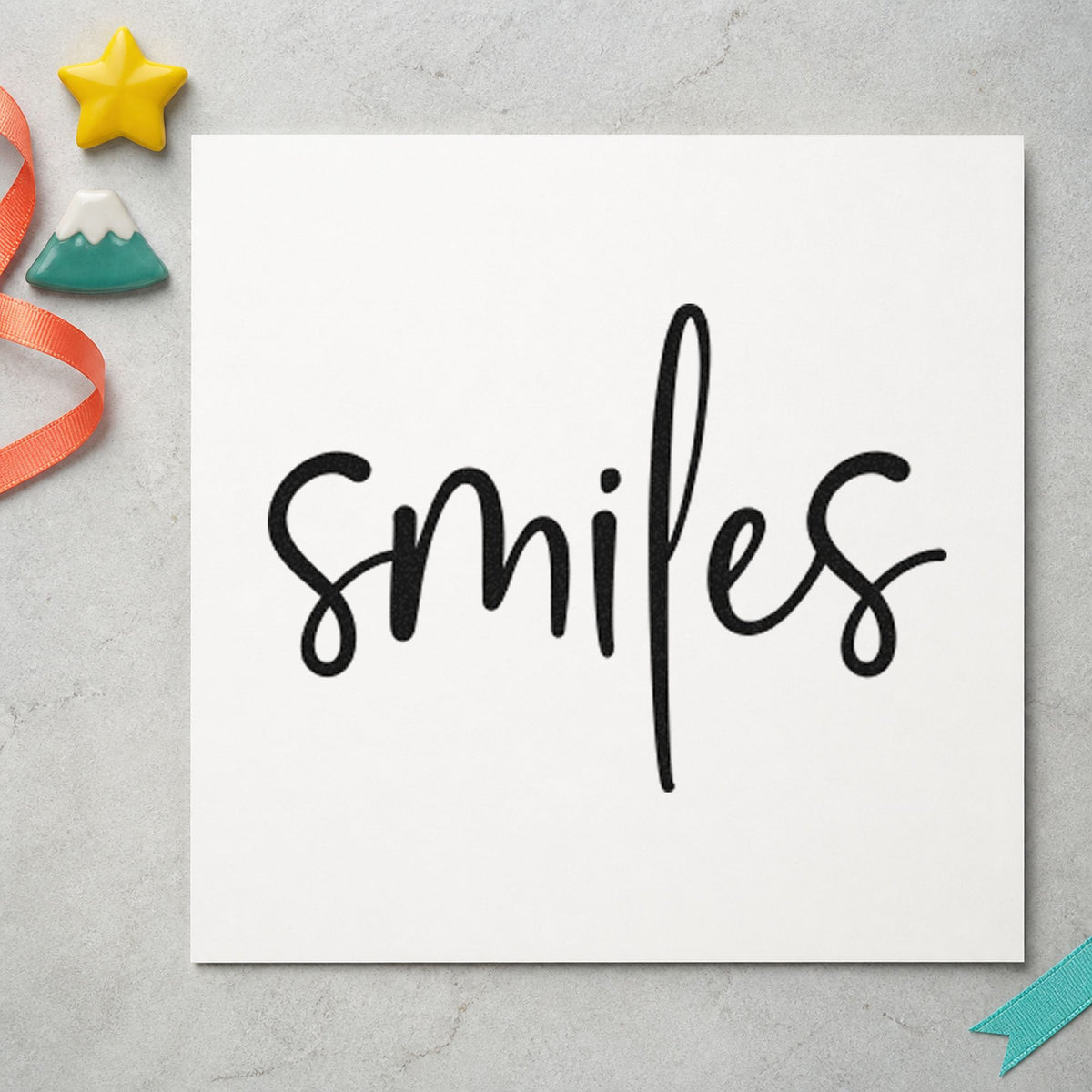 Smiles Simple Brush Script craft stamp in black ink on cardstock, an easy option for booth album page.