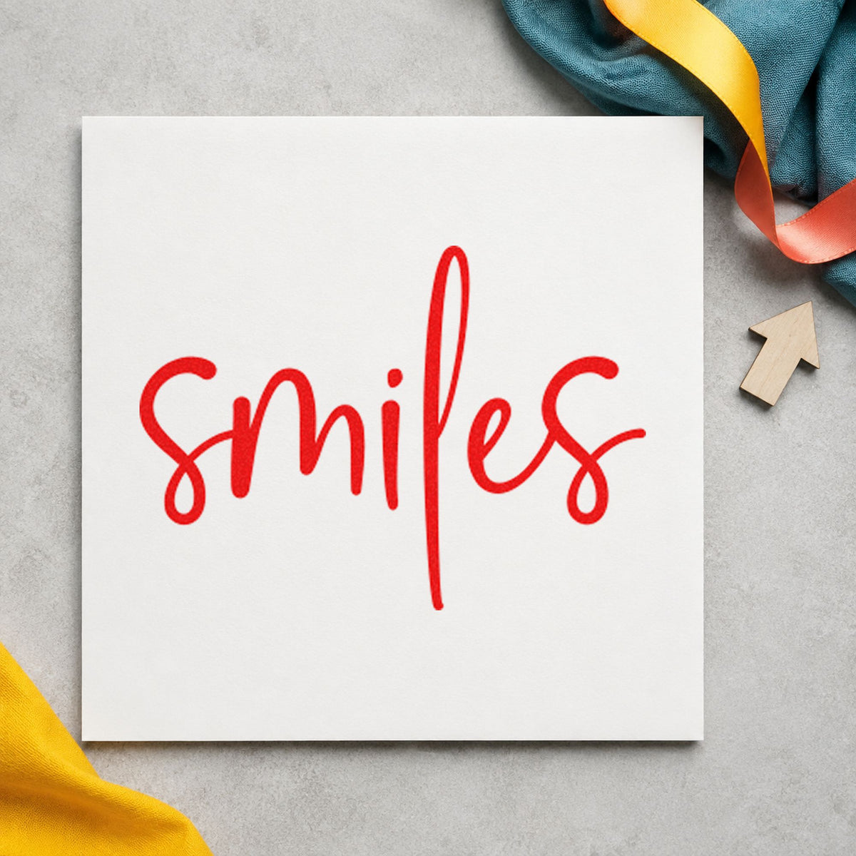 Smiles Simple Brush Script rubber stamp shown in red ink, stamped for projects such as bin prop labels.