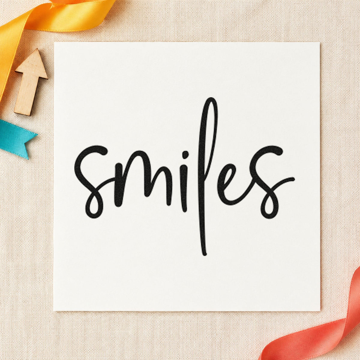 Smiles Simple Brush Script rubber stamp printed in black ink, ready for single word cards and similar paper crafts.
