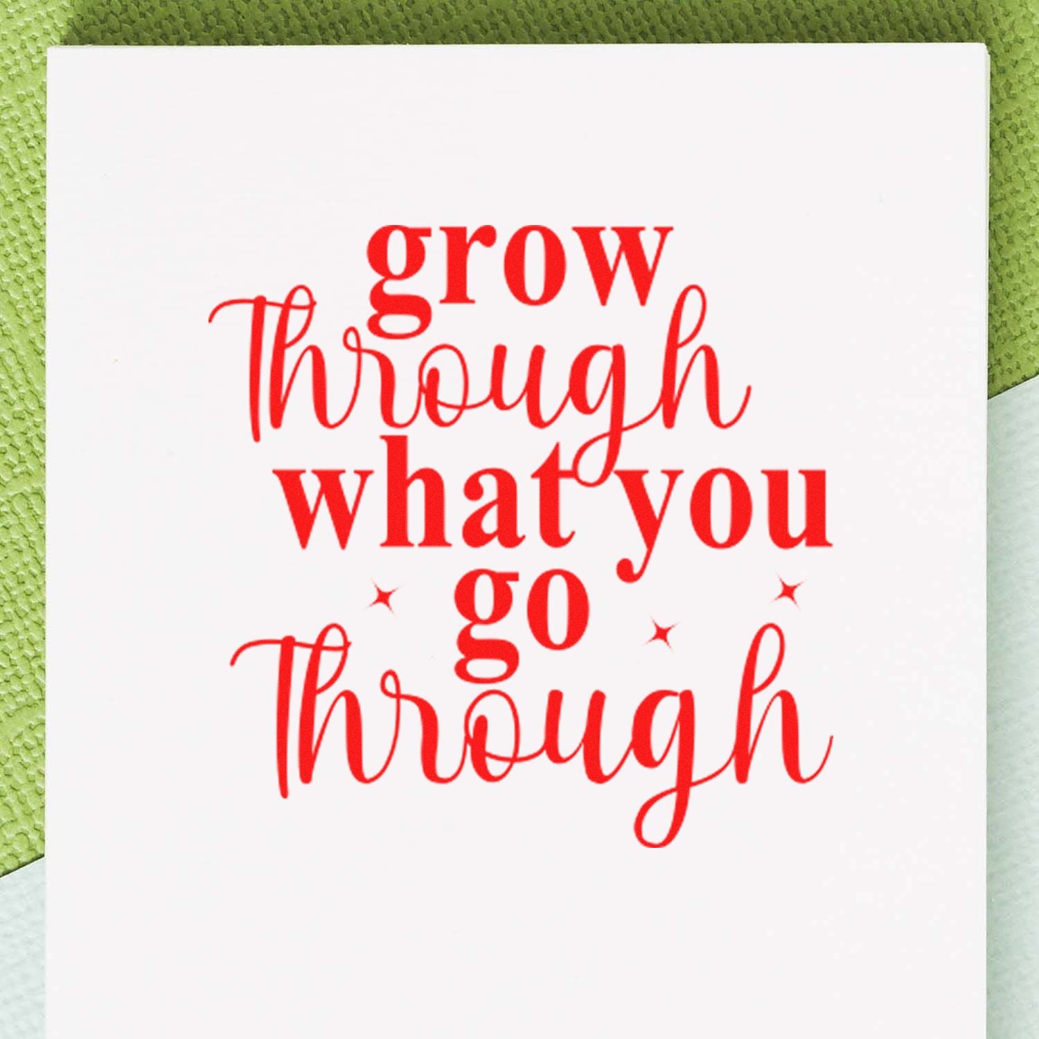 Red rubber stamp quote grow through what you go through with star accents on a white card.