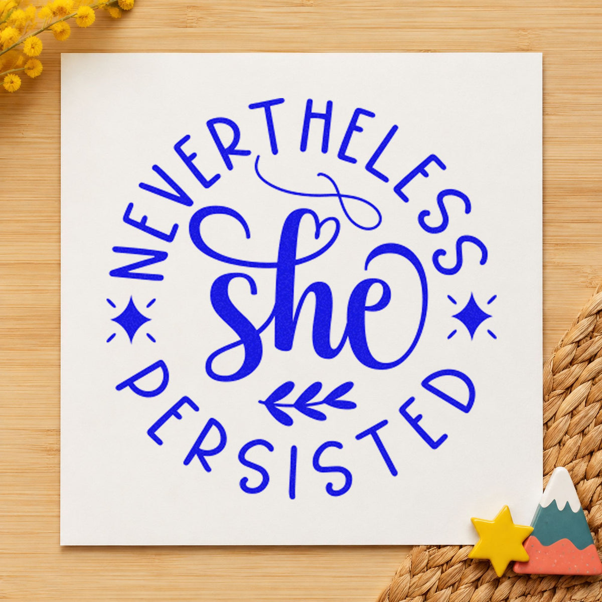 Nevertheless She Persisted Circle craft stamp in blue ink on cardstock, an easy option for book sleeve printing.