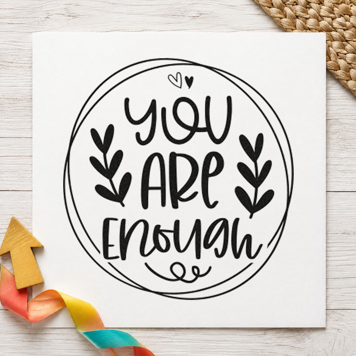 You Are Enough Circle Leaves craft stamp imprint in black ink on a handmade project, one idea being care box gift tags.