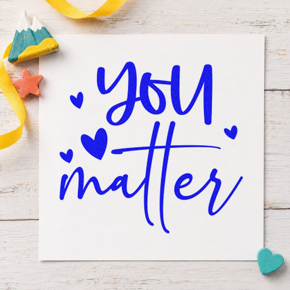 You Matter Scattered Hearts craft stamp in blue ink on cardstock, an easy option for cushion cover printing.