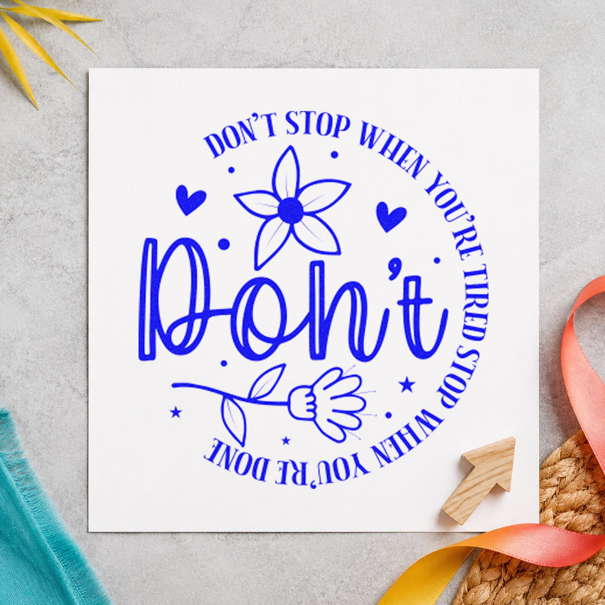 Don't Stop When Tired Floral craft stamp imprinted in blue ink on paper, a design suited to framed carrel wall.