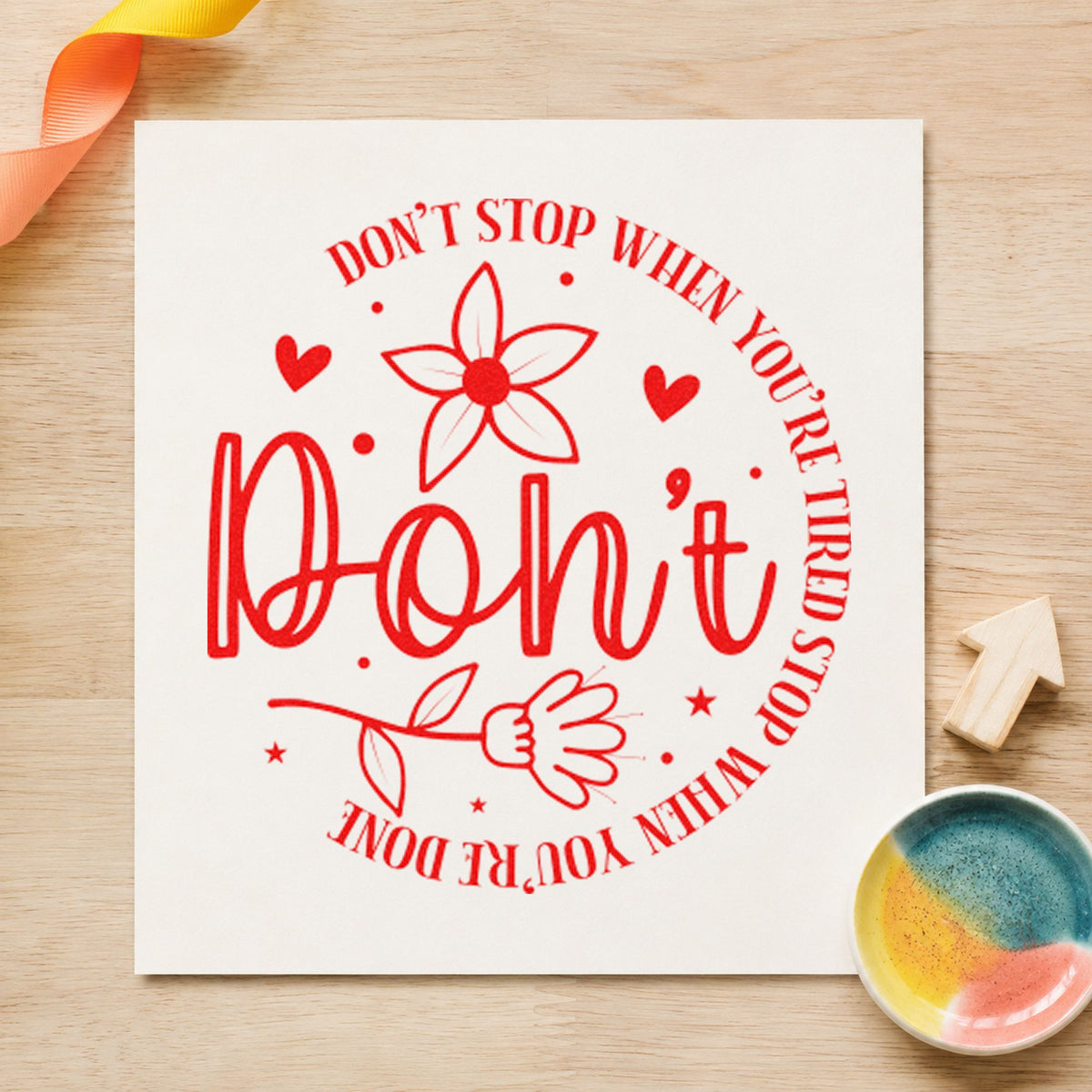 Don't Stop When Tired Floral craft stamp imprint in red ink on a handmade project, one idea being daily word cards.