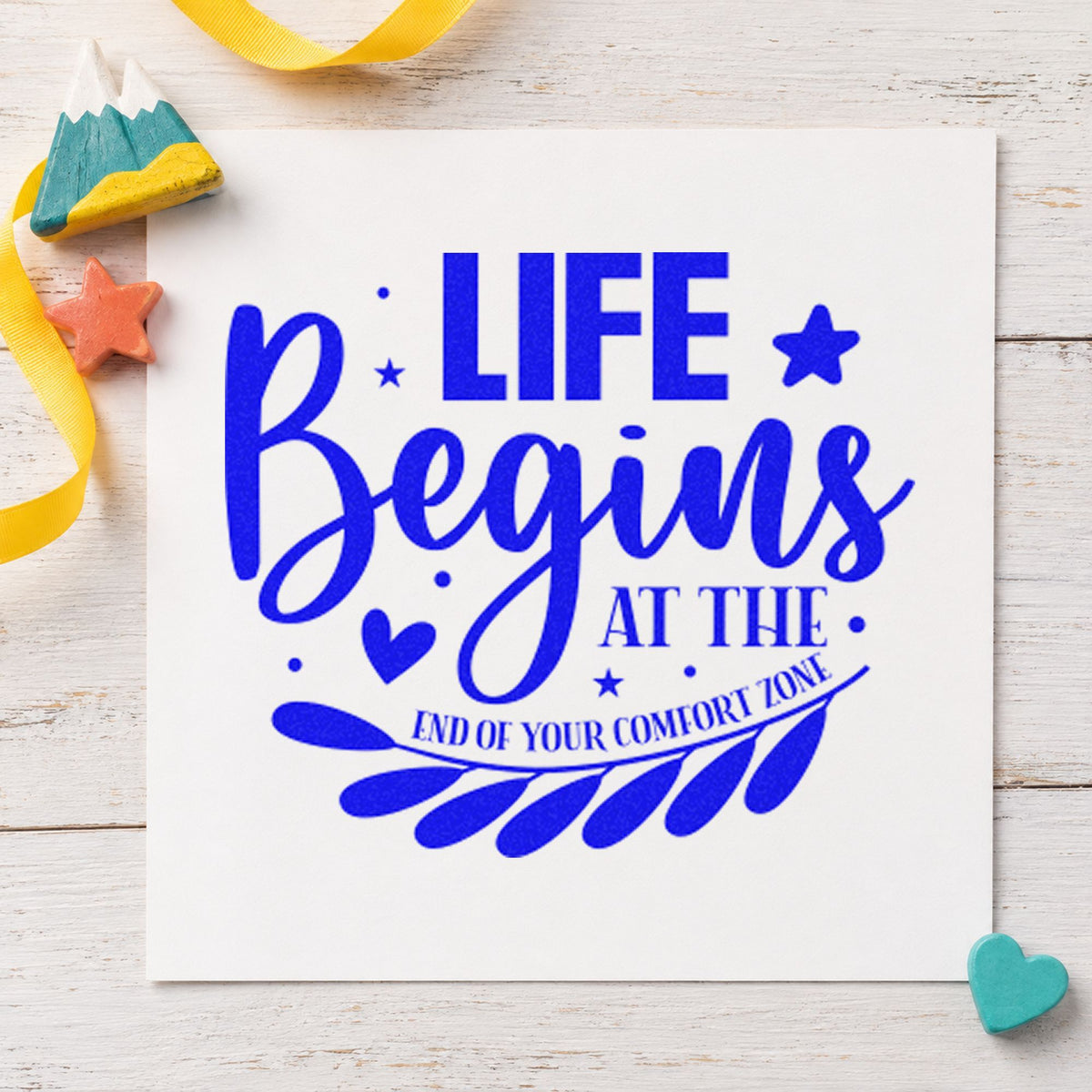 Life Begins Comfort Zone Leaves craft stamp imprinted in blue ink on paper, a design suited to framed back bar.