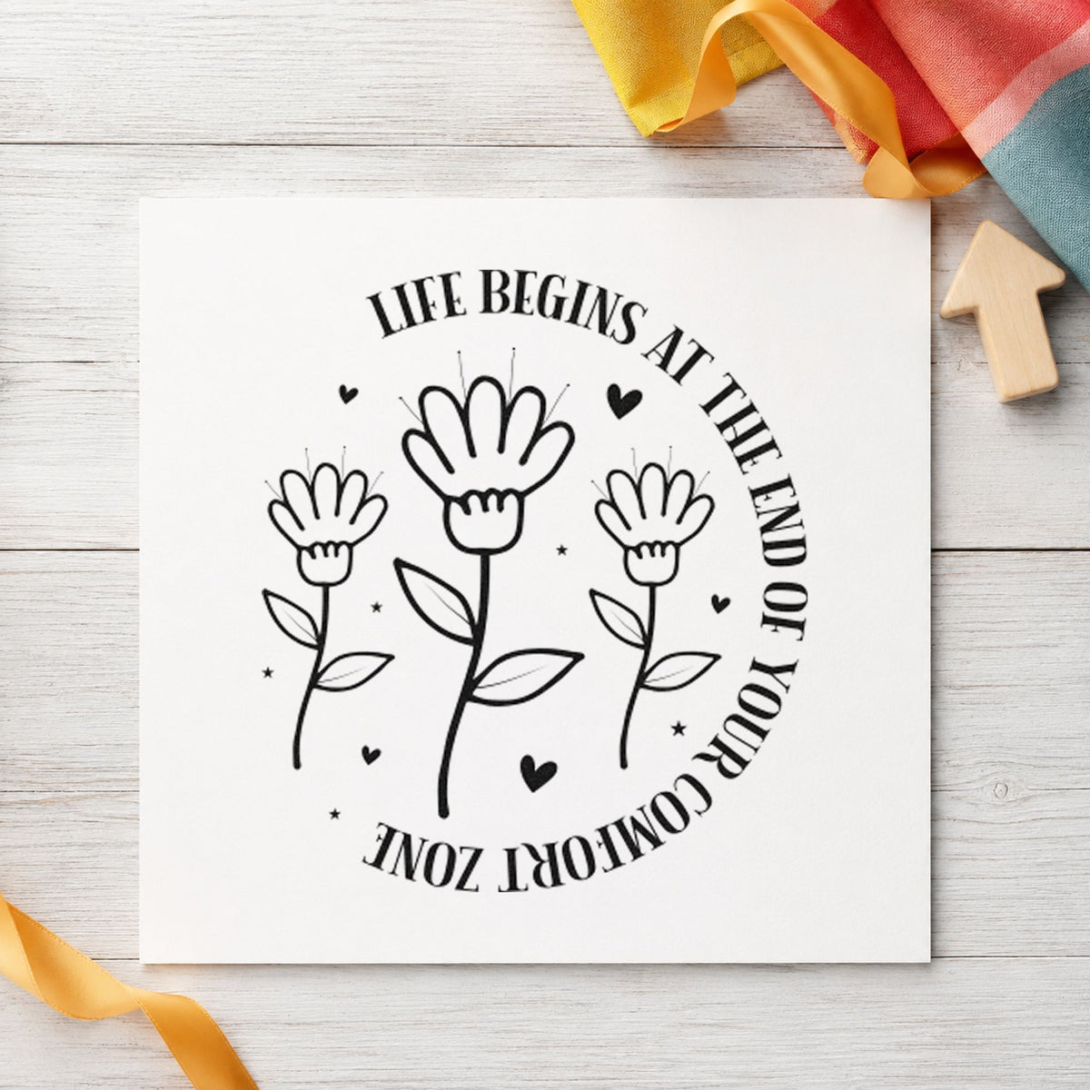 Life Begins Comfort Zone Flowers craft stamp imprint in black ink on a handmade project, one idea being shoe bag gift tags.
