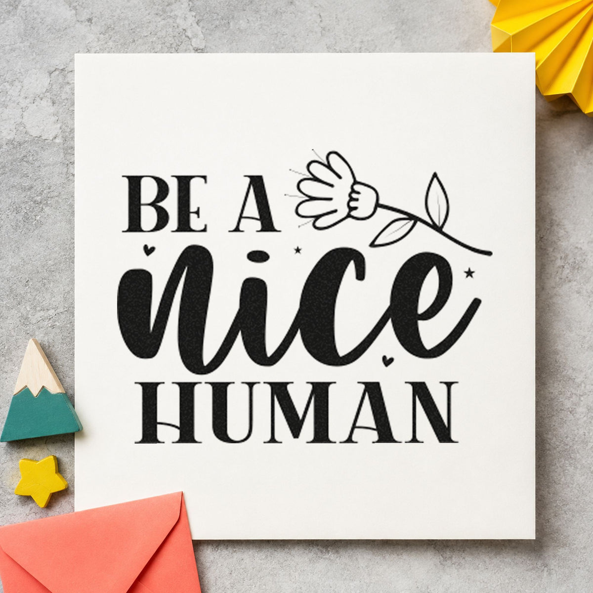 Be A Nice Human Flower craft stamp imprint in black ink on a handmade project, one idea being loan item gift tags.