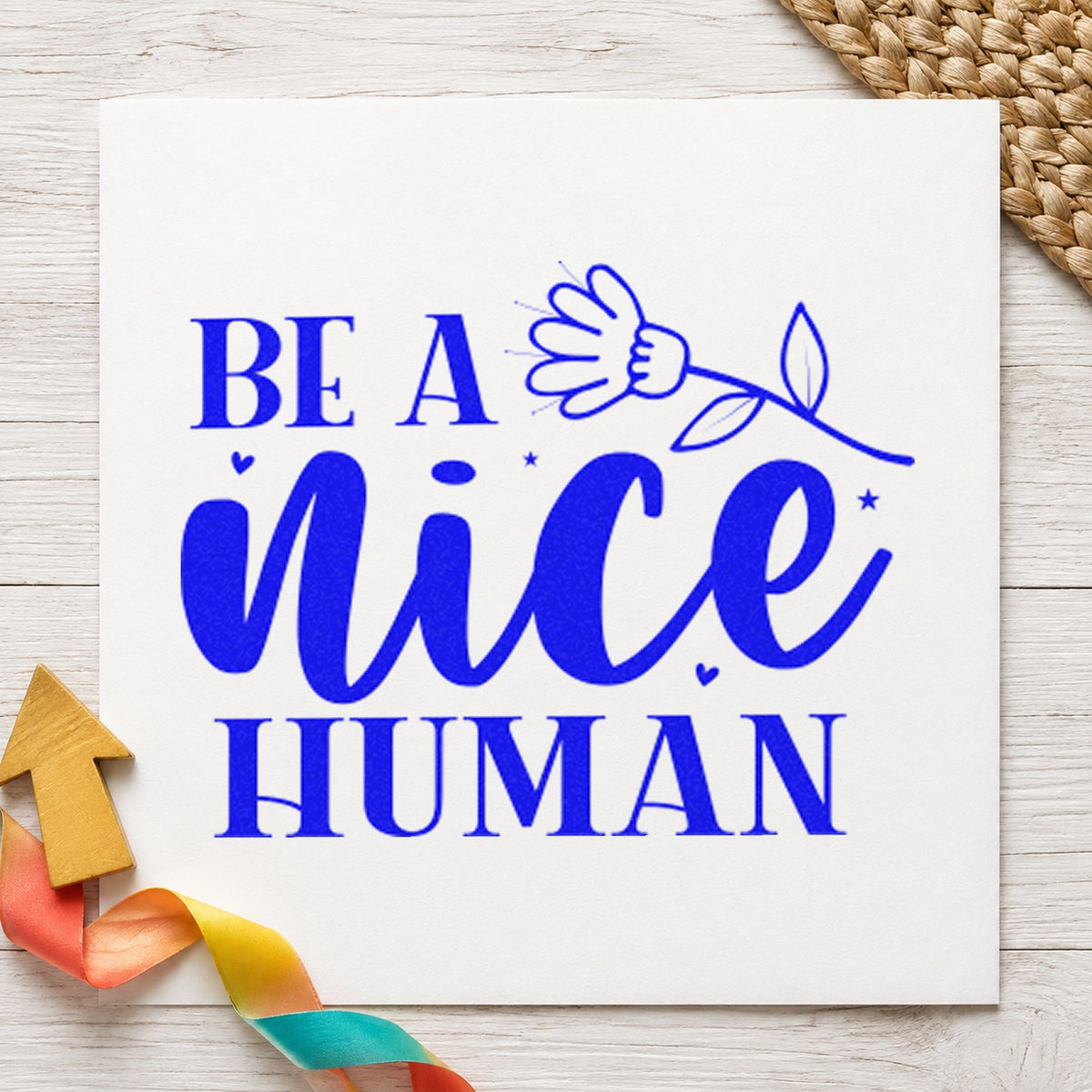Be A Nice Human Flower craft stamp imprinted in blue ink on paper, a design suited to framed storage shed.