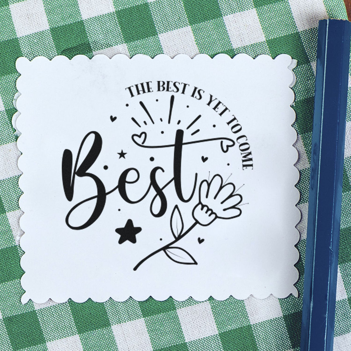 Best Is Yet To Come Floral Premium Wood-Mounted Stamp - Vintage Pro imprint stamped in black ink. The word "Best" appears with a flower, rays, stars, hearts, and curved text reading "The best is yet to come."
