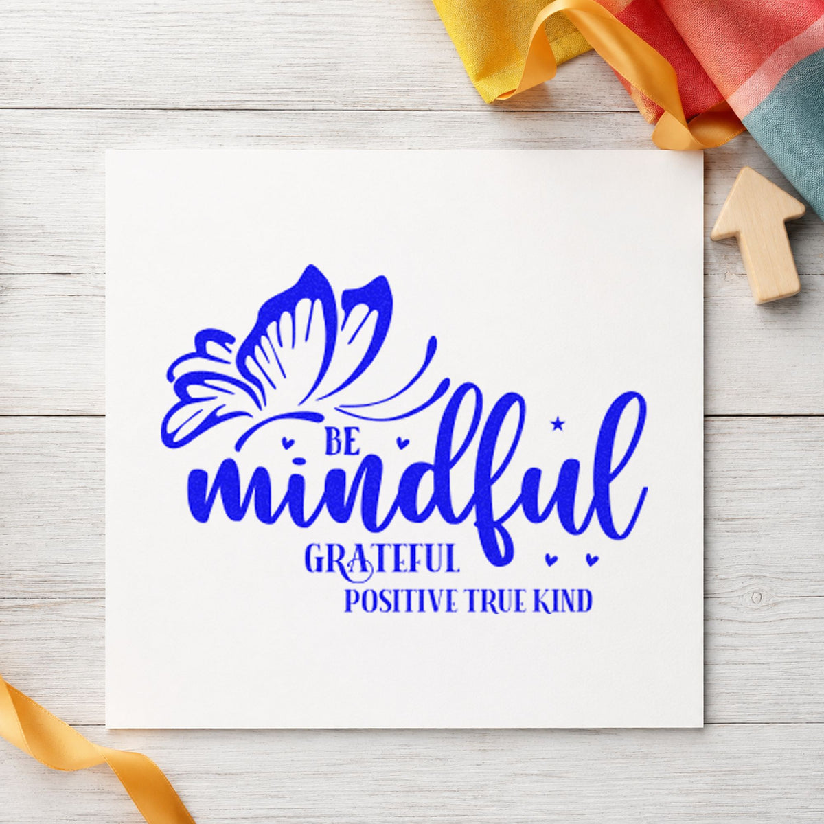 Be Mindful Butterfly Gratitude craft stamp imprinted in blue ink on paper, a design suited to framed reading corner.