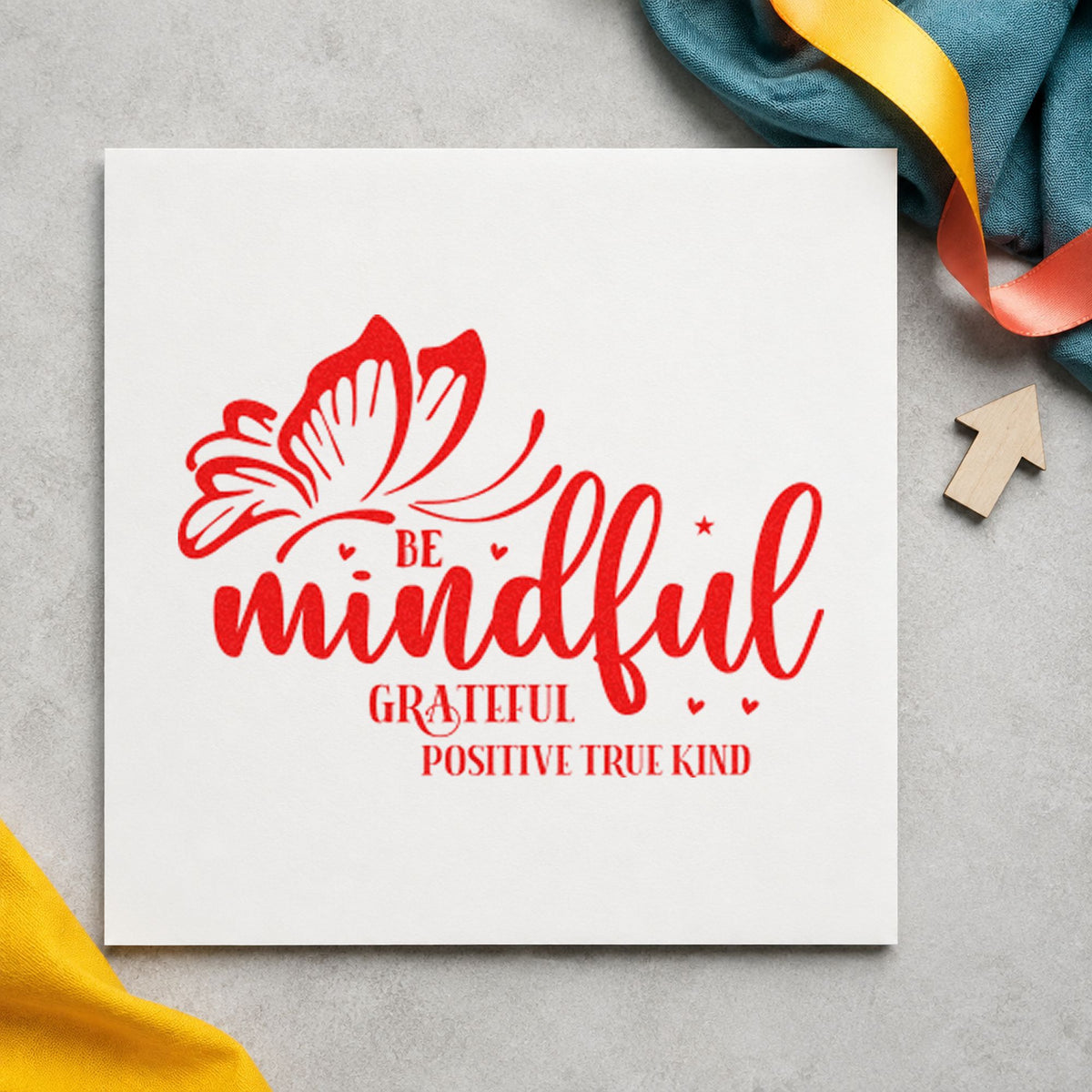 Be Mindful Butterfly Gratitude craft stamp imprint in red ink on a handmade project, one idea being feeling word cards.