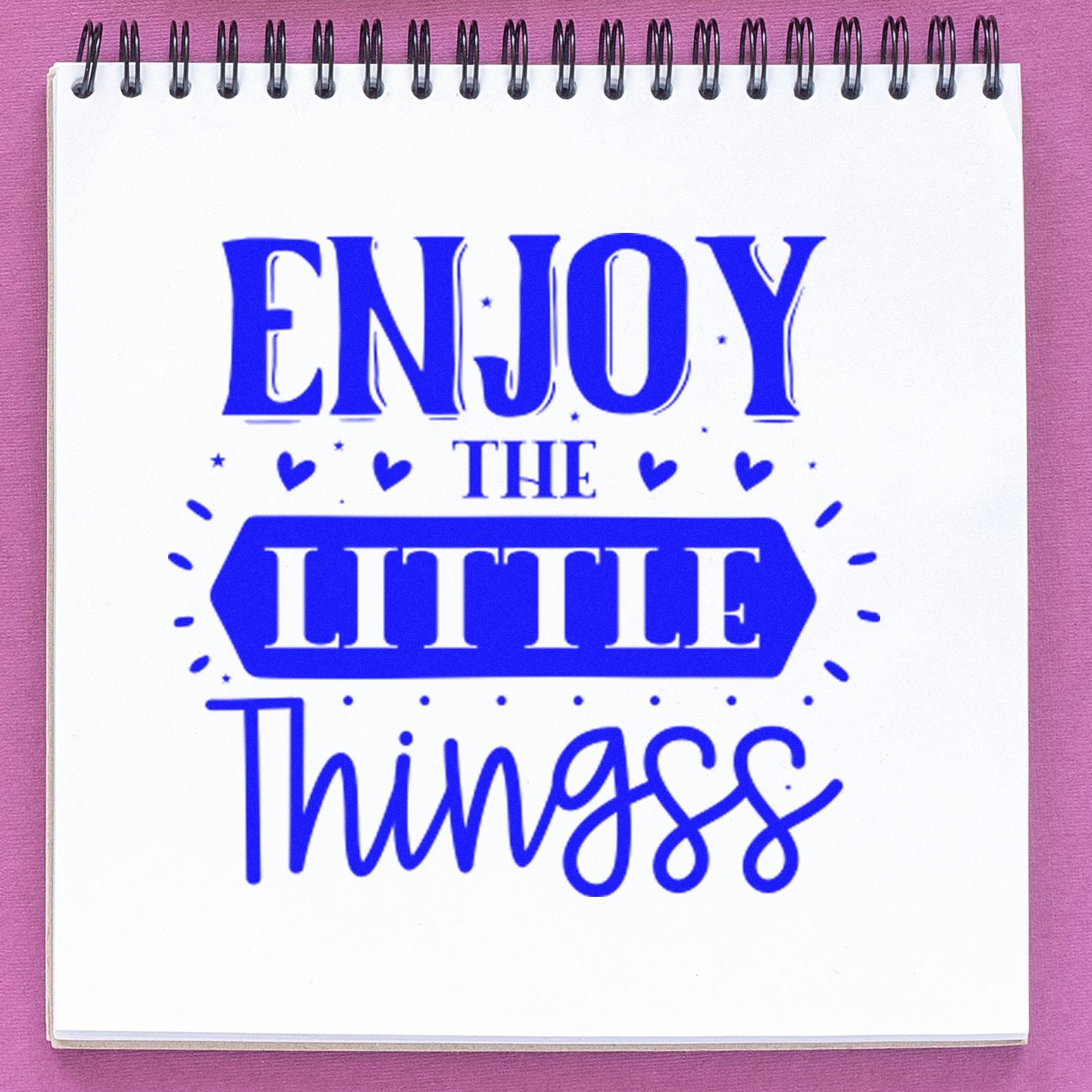 Blue Enjoy the Little Things rubber stamp on notebook page for inspirational journaling, planners, and crafts.