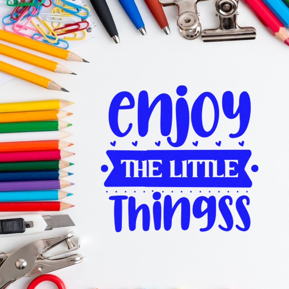 Enjoy The Little Things Bold rubber stamp shown in blue ink, stamped for projects such as collection album page.