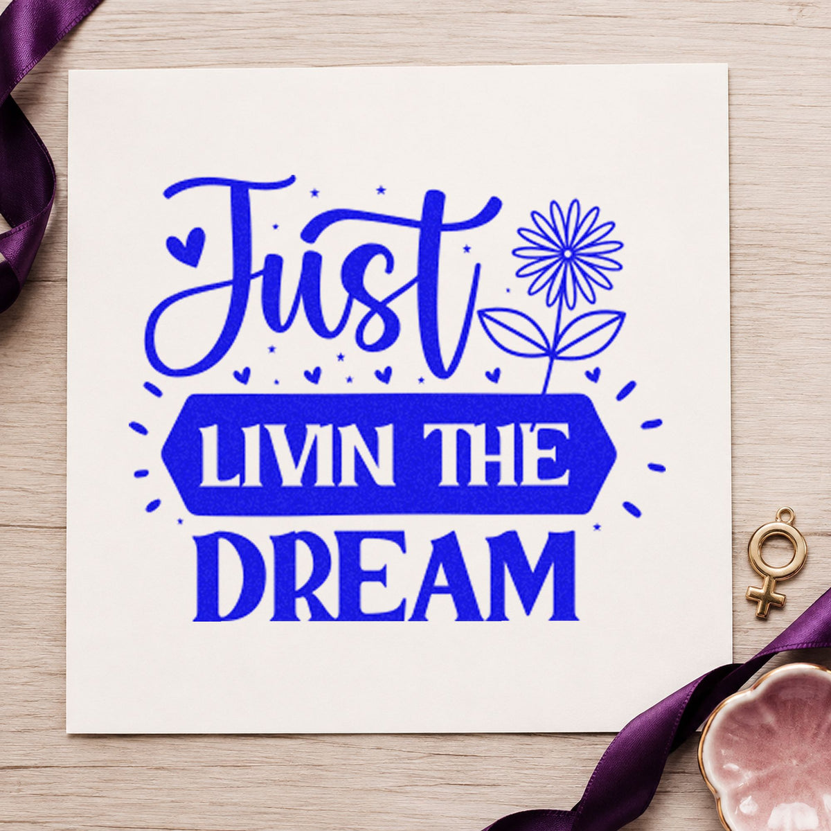 Just Livin Dream Flower craft stamp imprinted in blue ink on paper, a design suited to framed camp office.