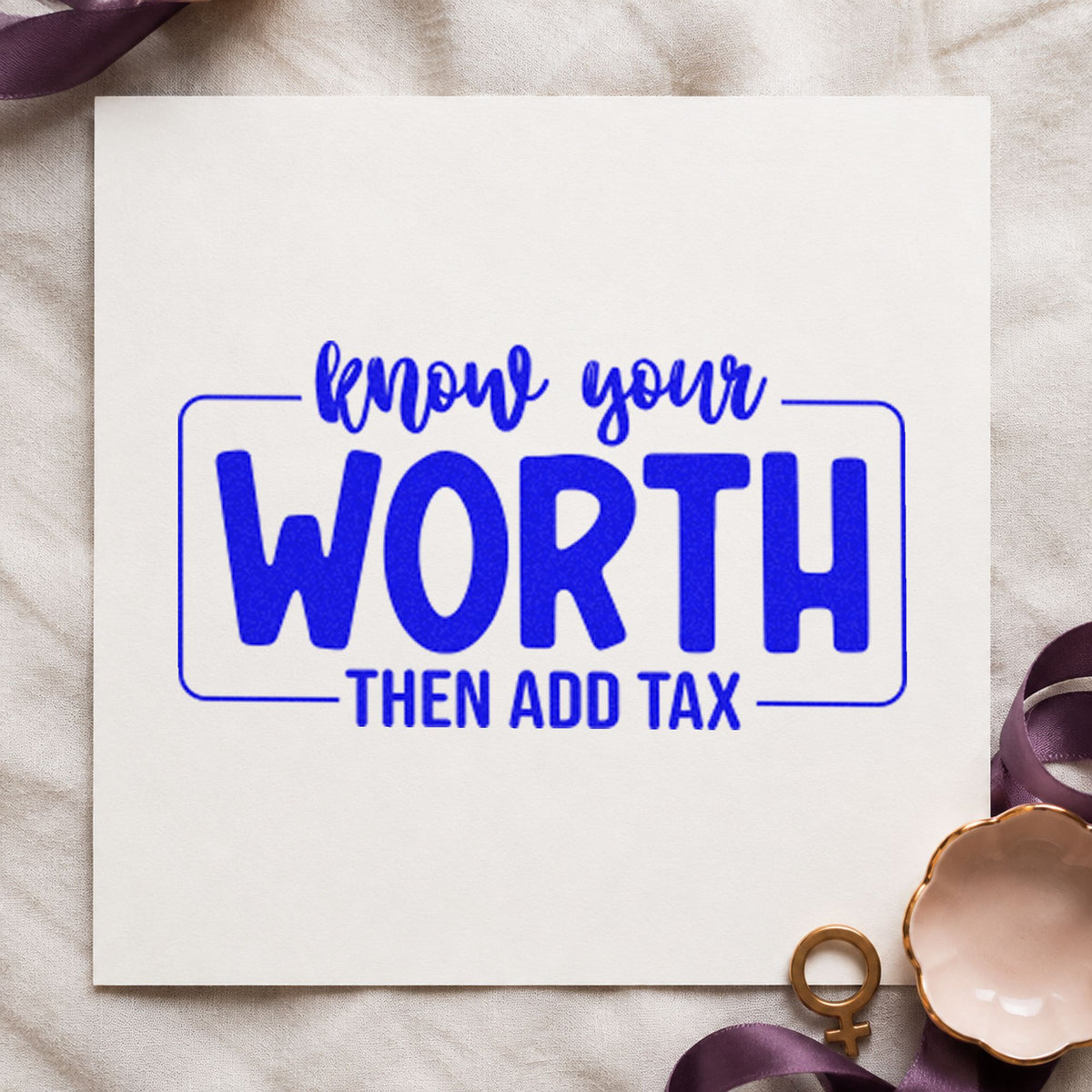 Know Your Worth Add Tax craft stamp imprinted in blue ink on paper, a design suited to framed studio vanity.