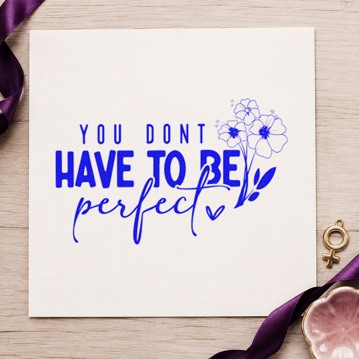 Don't Have To Be Perfect craft stamp imprinted in blue ink on paper, a design suited to framed shed door.