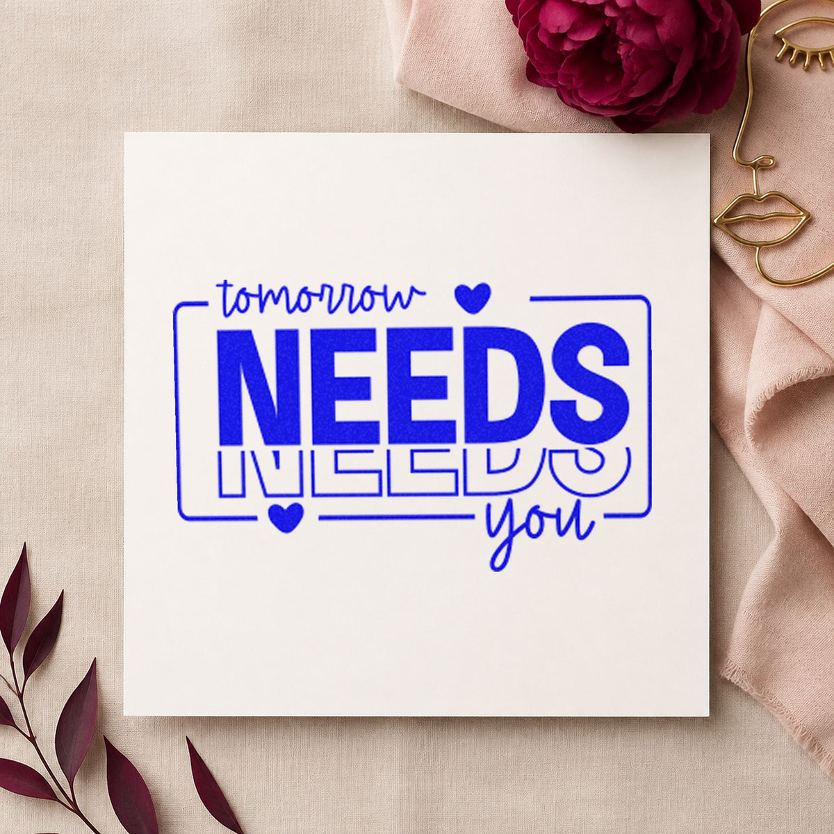 Tomorrow Needs You Repeated craft stamp in blue ink on cardstock, an easy option for volunteer tee printing.