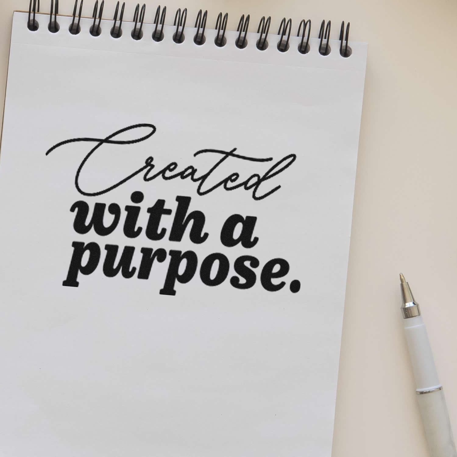 Custom rubber stamp design with the quote Created with a purpose on a notebook page, perfect for handmade branding.