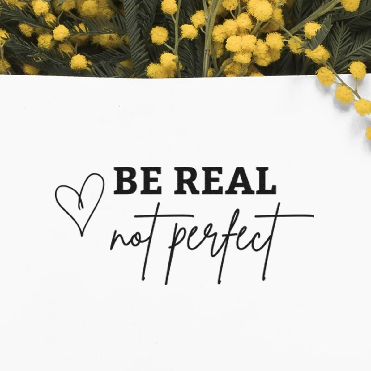 Be Real Not Perfect With Hearts Premium Wooden Stamp - Vintage Pro imprint stamped in black ink. BE REAL not perfect appears beside an outlined heart.
