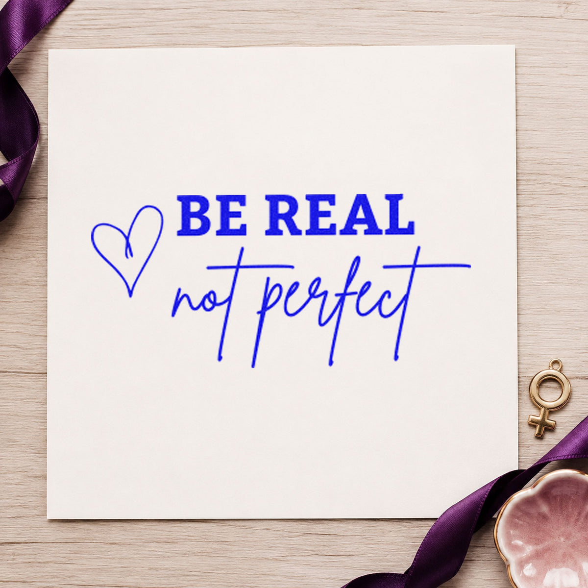 Be Real Not Perfect craft stamp imprinted in blue ink on paper, a design suited to framed hall gallery.
