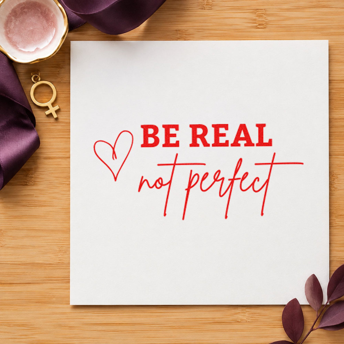 Be Real Not Perfect craft stamp imprint in red ink on a handmade project, one idea being family news cards.
