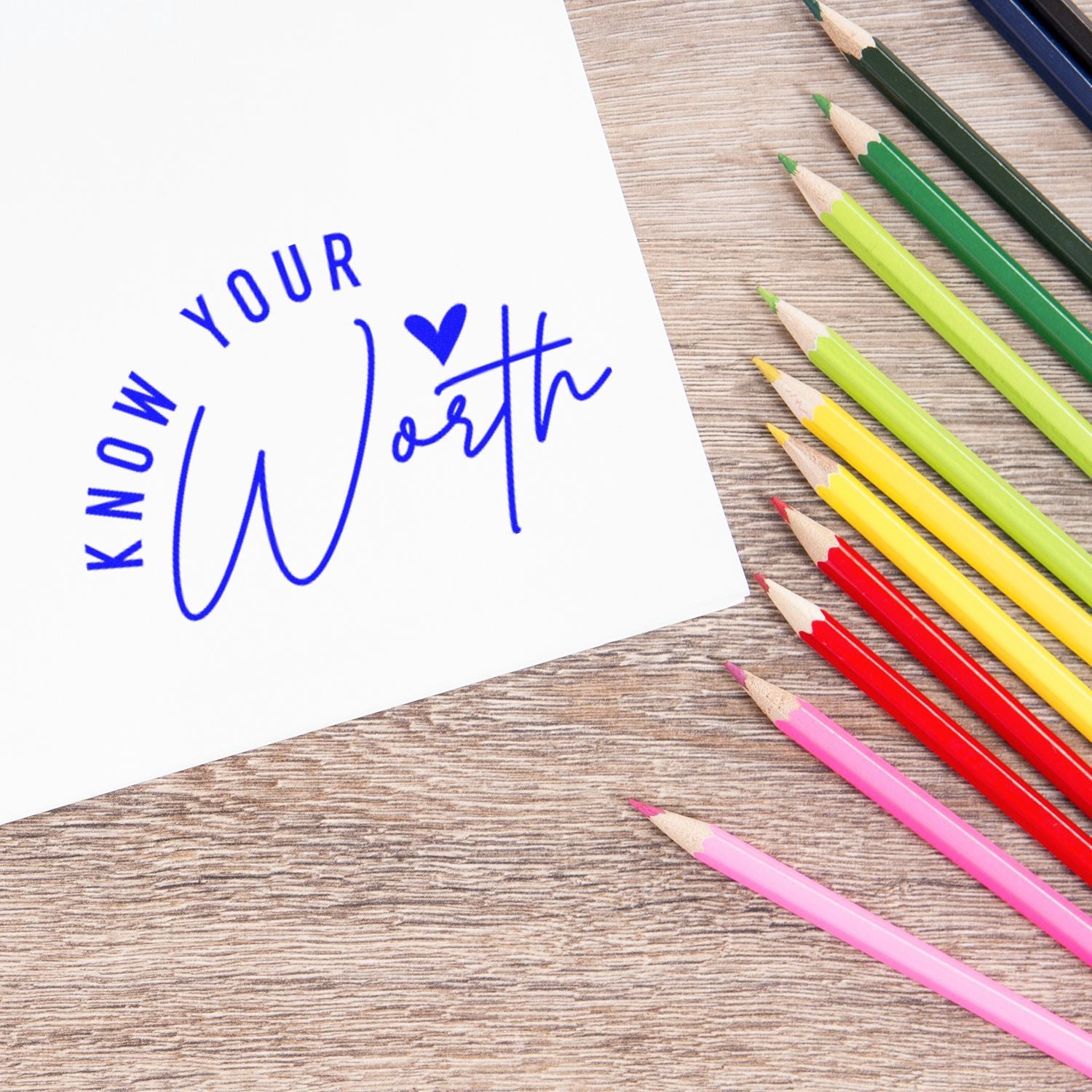 Inspirational Know Your Worth rubber stamp imprint on paper with colorful pencils, ideal for motivational stationery.