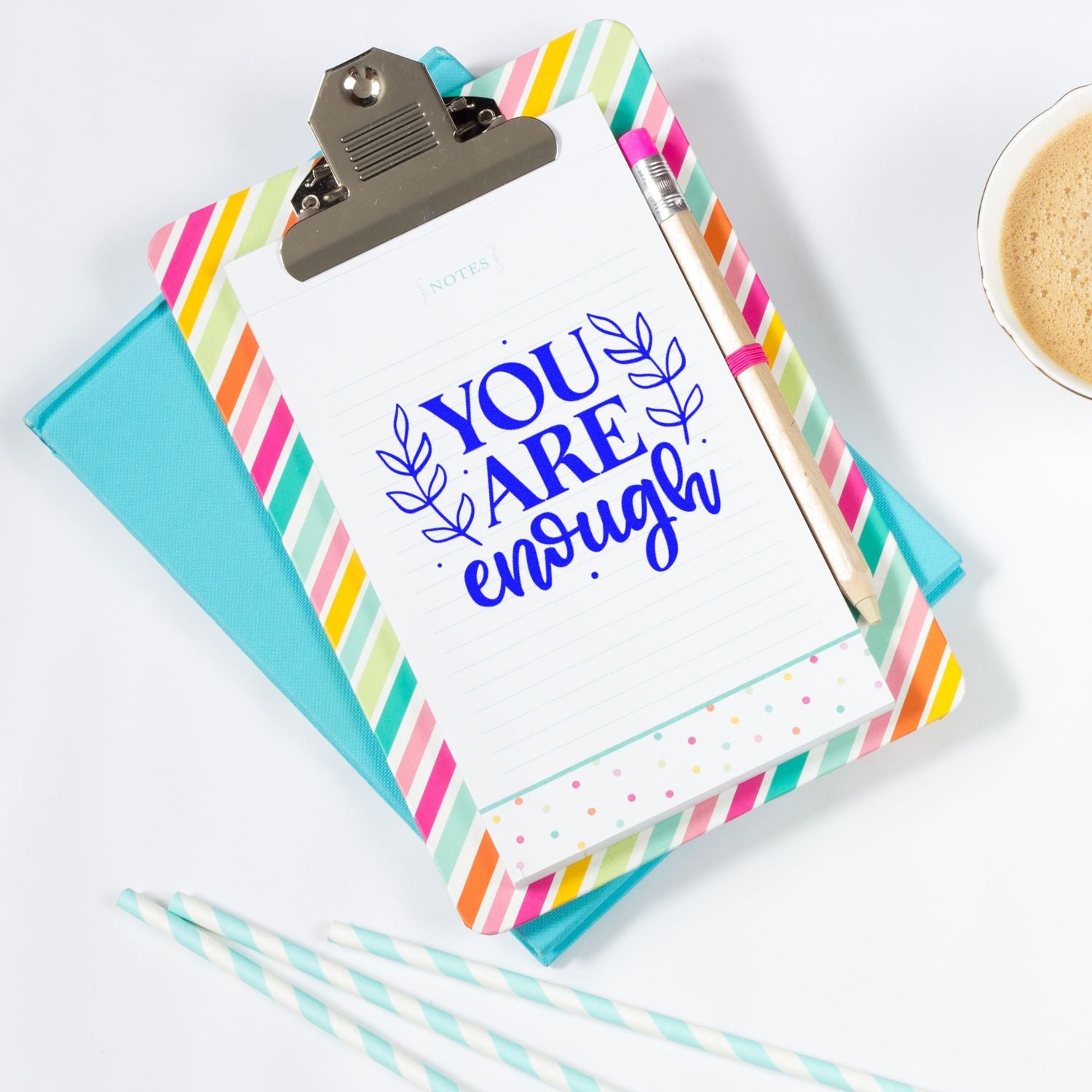 Inspirational rubber stamp design with blue You Are Enough text on a clipboard notepad for stationery and craft projects.