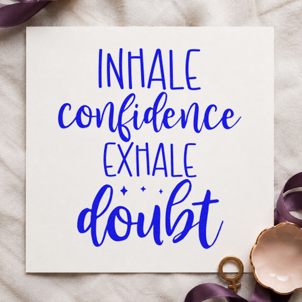 Inhale Confidence Exhale Doubt craft stamp imprinted in blue ink on paper, a design suited to framed board corner.