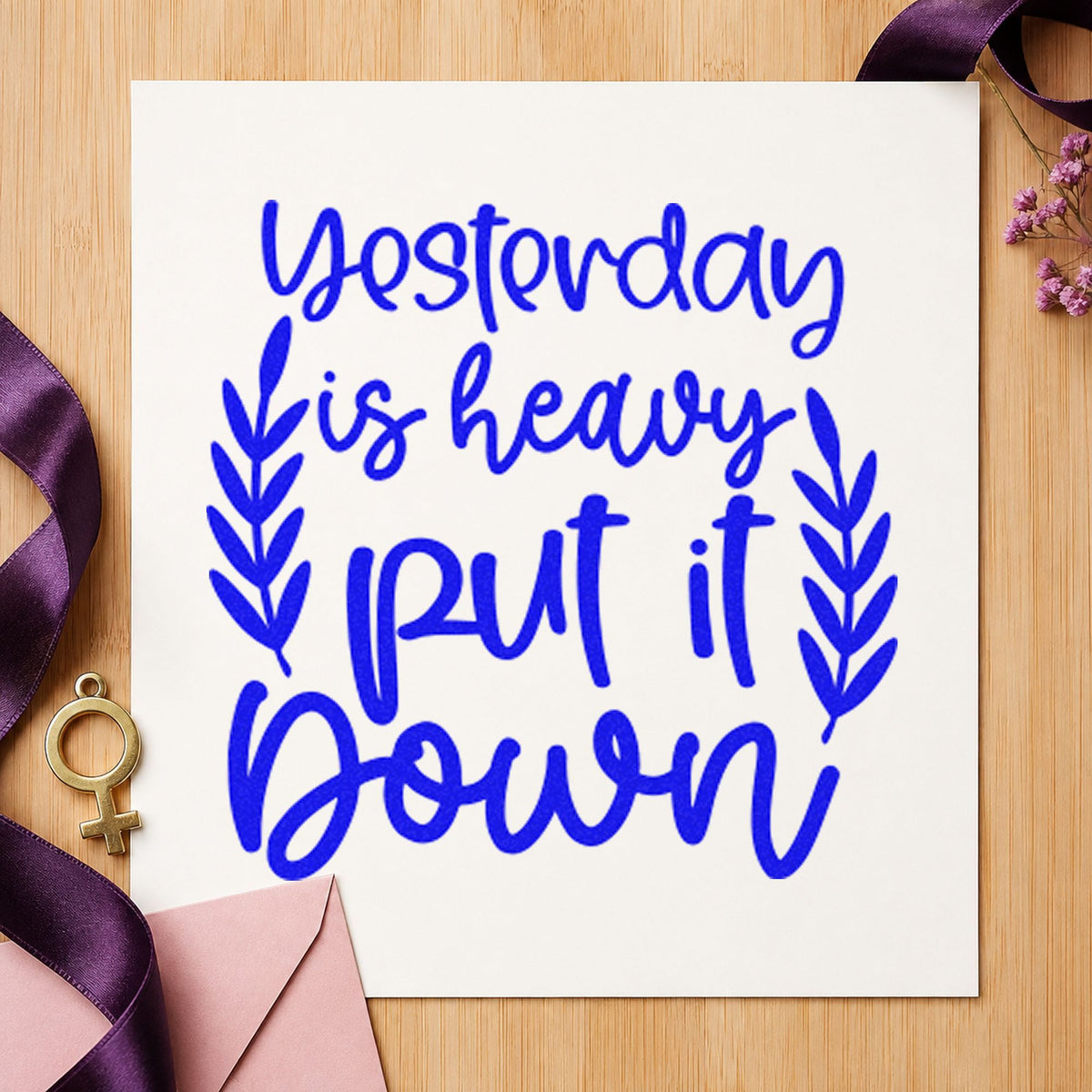 Yesterday Heavy Put Down craft stamp imprinted in blue ink on paper, a design suited to framed utility room.