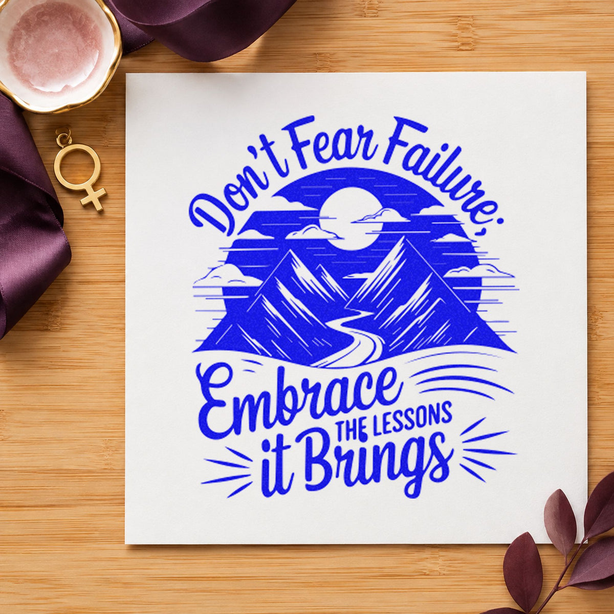 Embrace Lessons Failure Mountains craft stamp in blue ink on cardstock, an easy option for team tee printing.